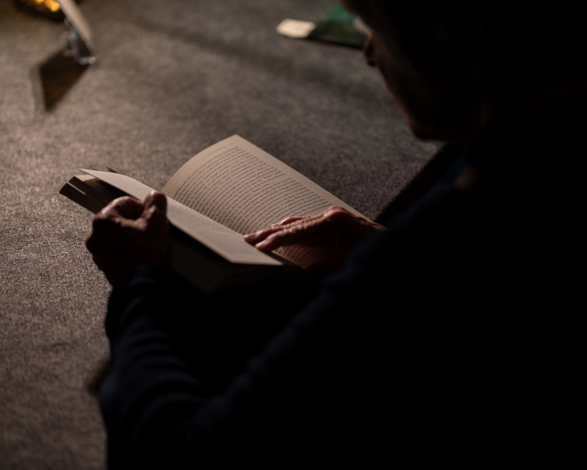 Installation view of a guest using the reading room.